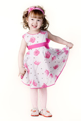 beautiful little girl in a dress with a flower in your hand