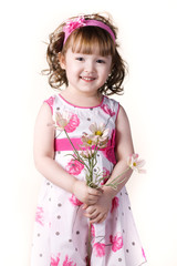 beautiful little girl in a dress with a flower in your hand