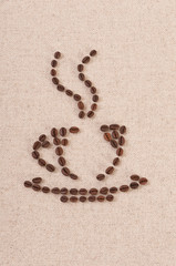 Coffee cup made of beans on linen