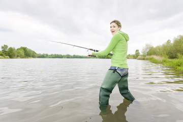 woman fishing in pond