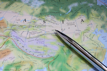 Fototapeta na wymiar silver pen on the Asia map.