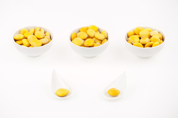 Lupins beans snack appetizer in small cups on white