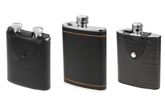 three black leather flasks for alcohol isolated on white