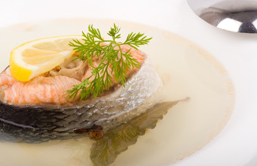Tasty fish soup with salmon and lemon