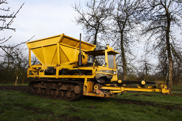 Obraz premium Big yellow machine - used for laying drainage stone