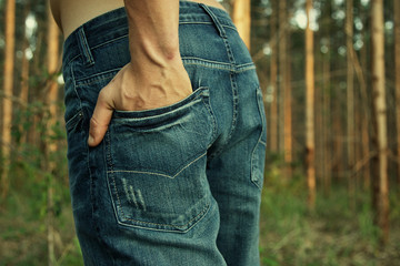 young man hands in rear jeans denim pants pocket