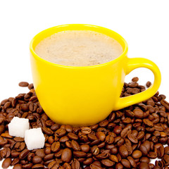 Yellow cup of coffee with beans