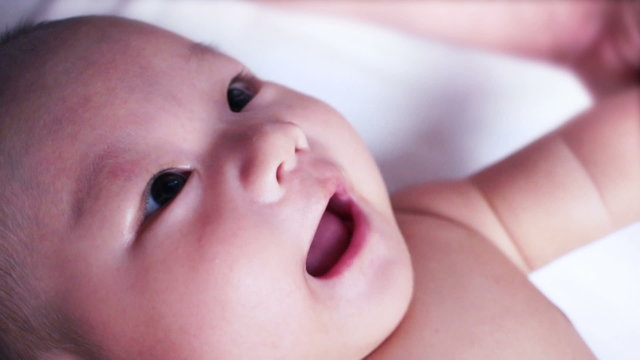 A Cute Little Baby Looking And Playing With Father.