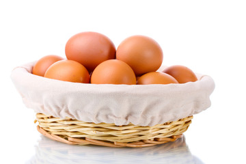 brown eggs in basket isolated on white