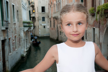 Fototapeta na wymiar Italy, Venice - Portrait of lovely girl on the bridge in Venice