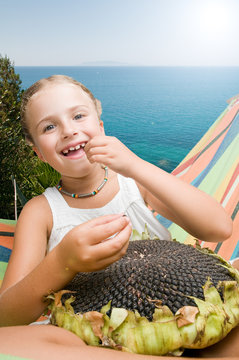 Girl in hammock with the seeds of the sunflower