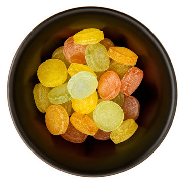 Color pastiles sweets in a black plate