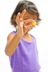 asian little girl showing a snack on hand