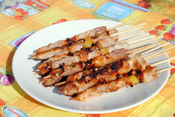 cocked pork kabobs grilled on skewers in a plate