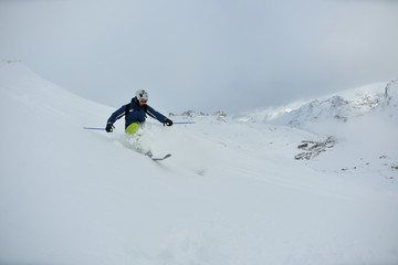 Naklejka na ściany i meble skiing on fresh snow at winter season at beautiful sunny day