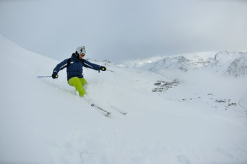 Naklejka na ściany i meble skiing on fresh snow at winter season at beautiful sunny day