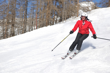 skiing on fresh snow at winter season at beautiful sunny day