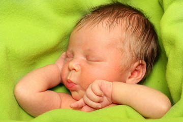 Sleeping Newborn Baby Boy in a Green Blanket