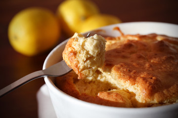 Mouthful of cheese soufflé on a fork, eating