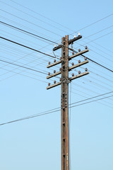 Old electric steel pole on blue sky background