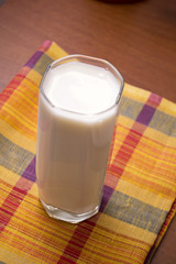 glass of milk on wooden table