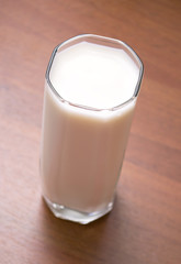 glass of milk on wooden table