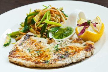Sworfish steak with steamed vegetables and spices