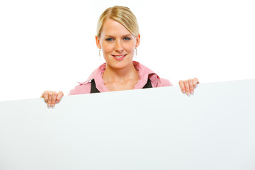 Happy woman showing blank billboard