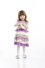 Portrait of a cheerful little girl with a bag