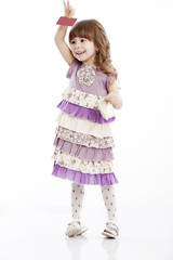 Portrait of a cheerful little girl with a bag and card