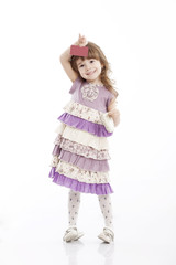 Portrait of a little smiling girl playing with a card