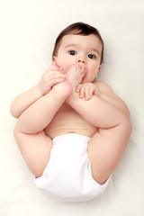 Adorable baby sucking his toes
