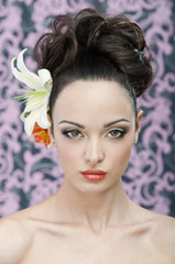 Beauty portrait with lily flowers in hair. Hi end retouch