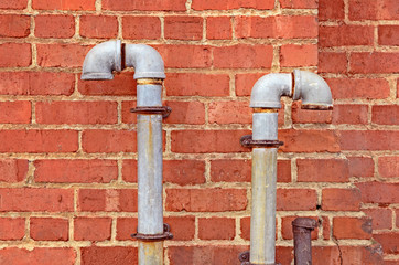 Rusty Pipes Against Brick Wall