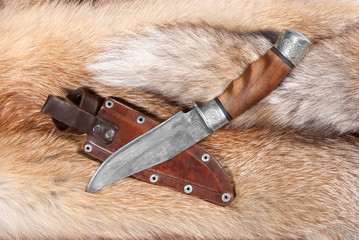 Hunting knife from braided hurlled on background of the fur