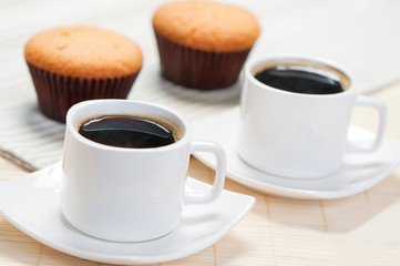 Two cups of coffee and cupcakes