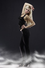 Caucasian blonde woman in full-length poses