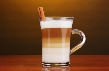 Fragrant сappuccino latte in glass cup and cinnamon