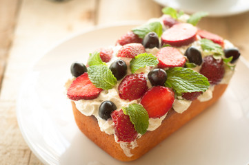 Lemon Pound Cake topped with whipped cream, fresh fruits