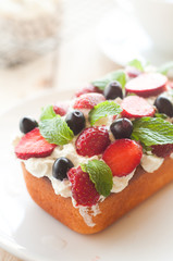 Lemon Pound Cake topped with whipped cream, fresh fruits