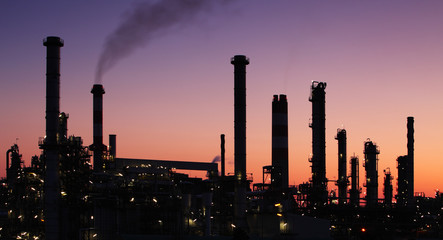 Oil refinery factory over sunrise - obrazy, fototapety, plakaty
