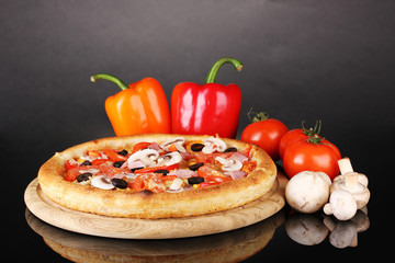 Aromatic pizza with vegetables and mushrooms isolated on black