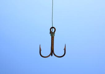 Treble fish hook on blue background