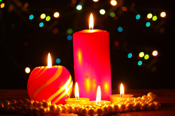 Wonderful candles on wooden table on bright background