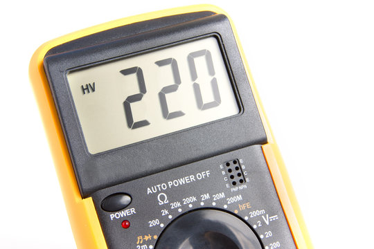 Digital multimeter showing 220 V