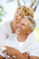 Mature couple smiling and embracing.