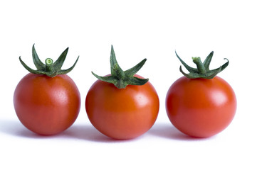 three cherry tomatoes isolated