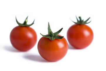 three cherry tomatoes isolated