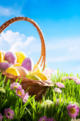 decorated easter eggs in the grass with flower