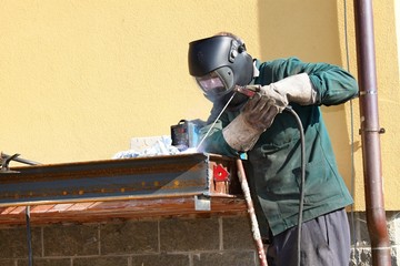 welder working outside in the metal construction, site